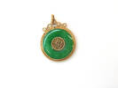 Circular jade and gold pendant