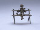 Figure, silver, on bench, knitting
