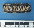 NEW ZEALAND shoulder title, worn by Gunner EA (Ted) Frost, WW2 [2007.78.23] - ruler view