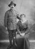 Studio portrait of Charles standing and Hettie Rankin sitting.