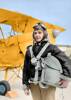 Colorized photo of R. Linton Jones in 1941, standing next to a tiger moth biplane in his flying gear. 
