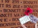 The Walls of Names is a series of 23 walls comprising 271 panels with the name of each of the (almost) 58,000 men and women who died while serving in Bomber Command cut from the steel by laser. This image shows the name of Bennett TSE, together with a poppy, a photo and a remembrance card placed there by myself