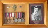 Frame made by William John Edge displaying photograph and service medals of William George Edge