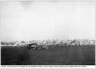 This is a photo of Ramleh War Cemetery, which is shown in the background. In front of Ramleh some army vehicles are shown. Written on the back of the photo are the words: "Ramleh in the background we stopped here for breakfast." 
The photo is one of a series of tiny photos taken by my father, Bernie/Bernard John Jenkins, during WWII; he sent these photos to his wife back home in New Zealand.
