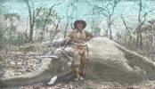 Outdoor scene in Southern African bushveldt, Clarence Henry BOULD standing in front of elephant he has shot.
