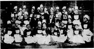 WELLINGTON HOSPITAL STAFF 1891-1892.
L to R - Back row, Mr.Hermansen, dresser, Mr. Toner, Nurses Brown, O&#39;Dell, Roberts, Hunt, Stevenson, Tasker, Miss Godfrey, matron, Nurses Playle, Farmer, Payne, late matron, Cheyne, Mr. Rountree, steward, Nurse Kerr. 
Sitting, Nurses Reese, Mason, Dougherty, Dr. Eivart, medical superintendent,&#39; Mrs. Swart, Dr. Martin, 
Nurse Heath dispenser, Nurse Richardson. 
Front row: Nurses Rowley, Willis, Snodgrass, Childs, Nellems, Heath, Beetham, Rutherford, Bagg, Anketell. 
Absent, Nurse Dorsett. Three stripes, head nurses; two stripes, senior nurses