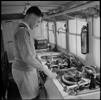Noel Palmer in the broadcasting van of the Broadcasting Unit at Maadi Camp in Egypt during World War II. Photograph taken on 1 May 1942 by M D Elias. https://natlib.govt.nz/records/22515835 