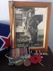 Photo taken in North Africa in 1942. Flag in background covered Alick’s Coffin.  Original dog tags and service medals in foreground