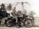 Man in World War 2 army uniform seated on an Indian motorcycle