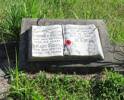 Memorial stone in shape of book on grave of parents.