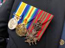 Replica medals (British War Medal; Victory medal and Croix de Guerre (Belgium)) for James Leslie MACGREGOR, worn by his grandson Bill at the Passchendaele Commemoration at the Auckland War Memorial Museum - 12 October 2018.