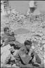 SJT E.D Bougen (Right) taking a break amongst the rubble of Monte Cassino, Italy 1944.
