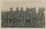 Top to bottom, left to right: 
1. Thomas Edward Thompson was a labourer born at Macetown.
2. Joseph Nelson Jenkins was a farm labourer from Crown Terrace. He was killed in Belgium on 12/10/1917. 
3. Unknown*
4. Unknown
5. Thomas Clarke Reid was a farmhand who lived at Speargrass Flat where the family ran the mill that was previously Gilmour's.  
6. Unknown*
7. David Charles Jones, bottom left, was a motor-driver from Arrowtown. 
8. Charles (Charley) Grahame Forbes was a farmhand from Arrowtown, who went on to serve in the police force.
9. Unknown
10. Sergeant Richard Stephen (Dick) Cotter, the son of Thomas and Jemima Cotter, of Arrowtown. He was killed in action on 24/10/1918. He is buried in France.  
11. Thomas Beckett, born in England, recorded as a farmhand at Lower Shotover. 
12. Bob Hunter, Wharehuanui, who wrote the postcard. 
* denotes men found in another photo and likely also from the Arrow.
Sources: Online Cenotaph; OTAGO WITNESS, ISSUE 3287, 14 MARCH 1917; New Zealand Army