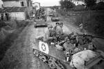 Māori Battalion troops in Bren Gun Carriers advance to the front near Rimini, Italy, in September 1944. The men in the nearest carrier are (left to right): Hone Pura Turner of Kihikihi (who would be killed in action on 31 January 1945), Te Tuhi Callaghan of Waihau Bay, Hone Jack Turoa of Muriwai, Poihipi Paora of Te Kaha, and 2nd Lieutenant Te Uaki (Monty) Searanke of Ōtorohanga.