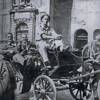 Paul Hakaraia sitting in the drivers seat of a carriage in Rome, with friends in the carrige.