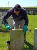 Grave marker being cleaned by Julien, CWGC team leader, July 2023. Taken by the contributor.