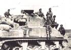 Photo of Gillies and his comrades /soldiers on top of tank