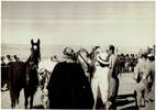 Decorating the placed horses in the bird cage. There were 10 or 12 European bints at the meeting and they were called in turns - 3 per race - to give the ribbon on the bridles.