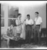 Repatriated NZ prisoners of war recording a message for family back home shortly after their arrival at 1 NZ General Hospital, Helwan, Egypt, during World War 2. From left: Charles Goodwyn Lewis (with recording equipment), John William Proudfoot (holding microphone), Sergeant Harry Taituha, Private C A Petrie. Photograph taken by George Robert Bull circa 3 November 1943.