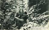 John Collins on patrol in the dense Malayan jungle while serving with the New Zealand Army.