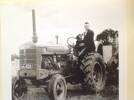 Howard Northey shown with tractor, baler and his dog