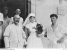 (Possibly) Staff Nurse Viola Everett  holding a live baby koala - and ANZAC service-men as hospital patients - at the Abbassia Hospital, Egypt 1916.