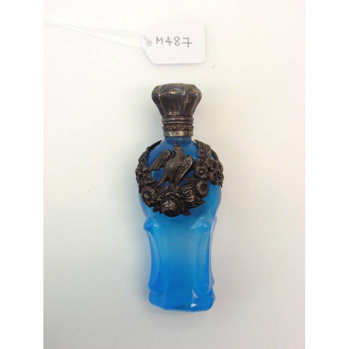 blue glass bottle with silver foliage detail