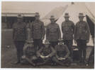 Group photograph, 8 soldiers posed in front of tents, September/October 1914. Likely to have been taken at Alexandra Race Course, Epsom. Message on back: 'Having a fine time in Auckland probably going this week or early next. Photo was taken last Sunday morning after church parade. These are the occupants of our tent. Back row feft to right: G. Frankpitt (14/107), K. Roughton (14/119), C. Carter, Max Compton (14/104), J. Bryson (14/100). Front row left to right: W. Cathro, N. Souness (10/523), J. Cabot [signed] Max'. Photograph originally on postcard stamped card, not posted. Note - K. Broughton is Norman Keith Roughton (14/119); C. Carter is Charles Denby Carter (14/102); W. Cathro is William Nichol Cathro; N. Sousness is Neil Souness (10/523); J. Cabot is John Frederick Cabot (10772). Image kindly provided by Max's daughter). Image as no known copyright restrictions.