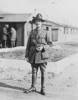 Portrait, standing outside military huts - No known copyright restrictions