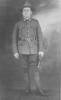William Baker standing, in uniform, holding gloves - No known copyright restrictions