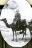 Portrait, sitting astride a camel, sphinx in background - No known copyright restrictions