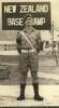 Photograph of Thomas James Herlihy standing beneath sign "New Zealand Base Camp", Korean War. Image is subject to copyright restrictions.