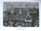 Group photograph, Phillip Cullen centre, with full uniform, companions in in various uniforms including sleeves rolled up, braces, different hats - No known copyright restrictions