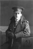 Portrait, seated, wearing great coat and cap - No known copyright restrictions