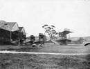 Flying boats in front of three hangars at the Walsh brothers flying school - No known copyright restrictions