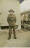 Portrait, standing outside army hut, washing on line in background - This image may be subject to copyright
