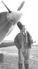 Portrait, Stanley de Vere standing in front of plane, propeller behind him - This image may be subject to copyright