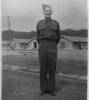 Portrait, standing on a road in front of barracks - This image may be subject to copyright