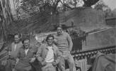 Group, WW2, Armoured Regiment, 4 soldiers leaning on a tank: Left to right Jack Matheson (81317), Herb Johnston, "Yogo" Ashwell & Jesse Sutherland with camouflaged tank in Italy. - This image may be subject to copyright