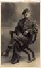 Portrait, wearing beret, studio photograph seated in chair - This image may be subject to copyright