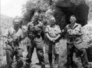 Group, 4 soldiers, standing in the countryside, Crete. Left to Right: Robert Bond (Bruff 9229); Dan Davin; unknown soldier; and Cunningham. - This image may be subject to copyright
