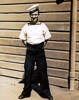Portrait, WW2, Gilbert Hogan standing at ease in front of wooden buidling (kindly provided by his daughter Lynn) - This image may be subject to copyright
