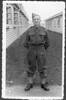 Portrait, WW2, full length, taken on enlistment, standing at ease outside in between wooden huts, - This image may be subject to copyright
