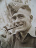 Portrait, WW2, wearing cap with badge, [hand]knitted jumper and pipe, Jack Callaghan (kindly provided by family) - This image may be subject to copyright