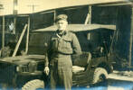 Portrait, WW2, soldier standing in front of jeep, wooden hut, cigarette in hand, wearing beret. Godfrey Perkins 20/641254 at Mizuba 1946 - This image may be subject to copyright