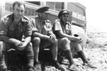 Group, WW2, soldiers leaning against a truck left to right: Frederick Kelly Driver (3532), Major Owen Bracegirdle (3127) and Captain Toogood, Western Desert 1941. - This image may be subject to copyright