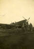 Group, three airmen, Bob, Jesse Pearse (NZ40427), Frank [Murphy (NZ411928)?] in assorted flying uniform standing at the nose of a fighter at P'Head - This image may be subject to copyright
