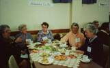 Reunion, war brides, Mt Eden War Memorial Hall, Auckland ca. mid 1990s, 5 women seated at a table with Athalane (sic) [Athlone] Castle sign. Left to right: unknown, unknown, ?Eileen Beresford wife of Keith Beresford (RNZAF), Val Wood, unknown. - This image may be subject to copyright