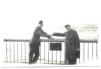 Niagara, 1942, shaking hands across the border in the middle of the Rainbow Bridge, brass plaque marks the line (L to R, Peter Day, Ray Mellsop), print - Auckland War Memorial Museum - Tāmaki Paenga Hira PH-2004-59-2. This image may be subject to copyright.