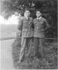 Brothers serving as airmen (from left to right) James 'Jim' (NZ404957) and Jack Menzies Smith (NZ403040) standing on the grass. - This image may be subject to copyright
